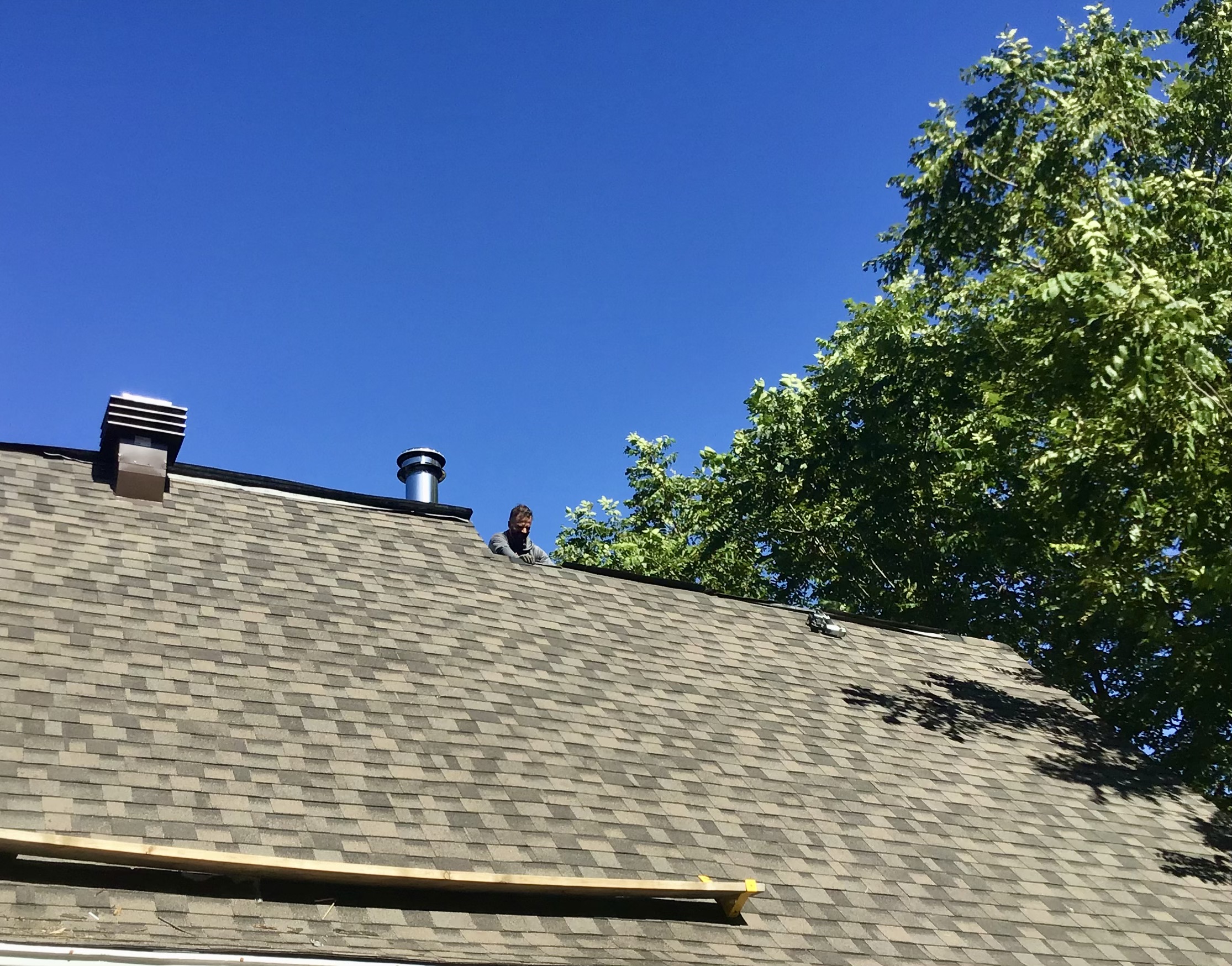 Older white woman with gray hair she is smiling and wearing a winter sport jacket she is relaxed and happy Bauduy roofing saved her roof from disaster